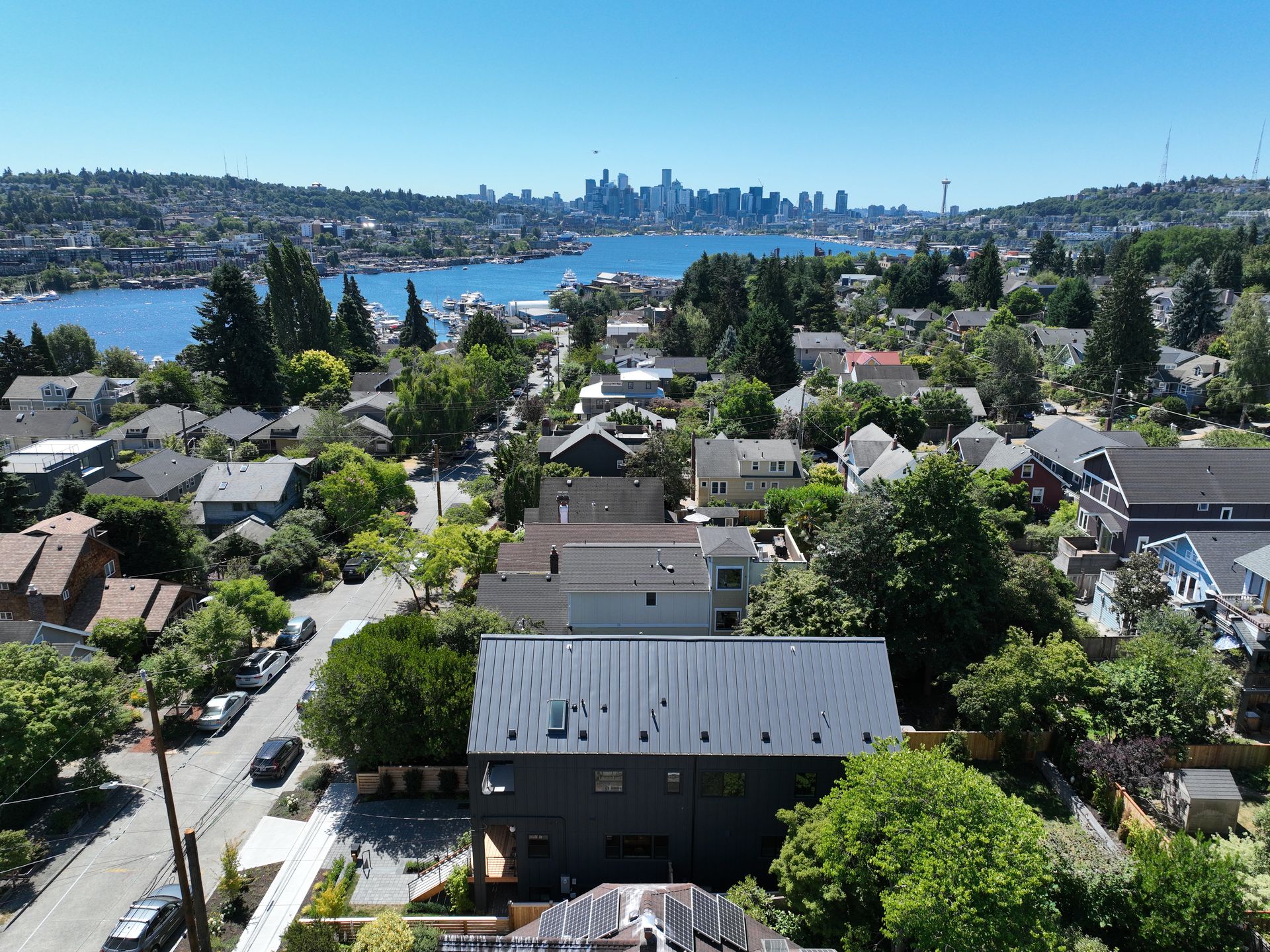 An aerial view of a residential area with a city in the background