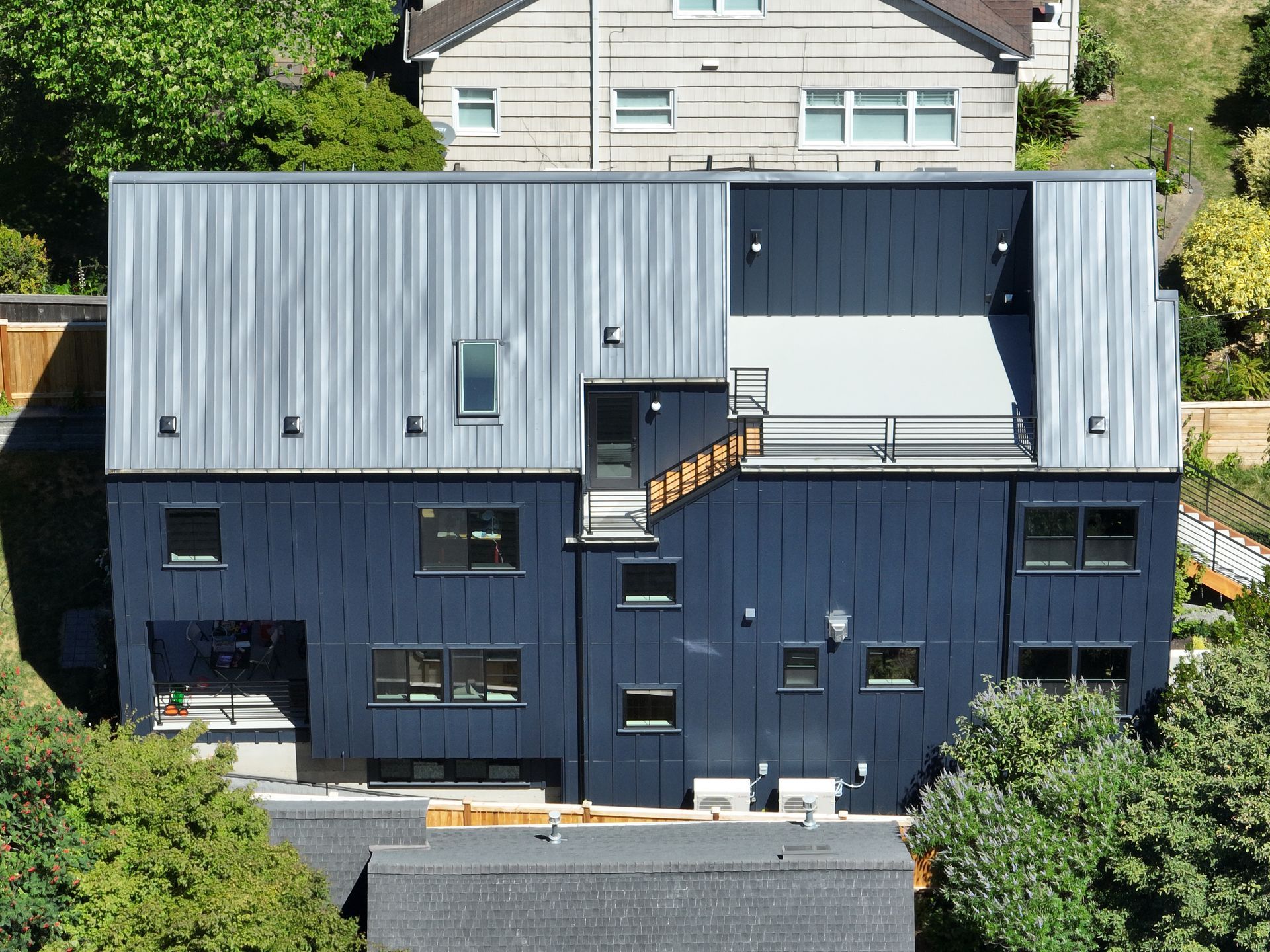 An aerial view of a house with a black roof