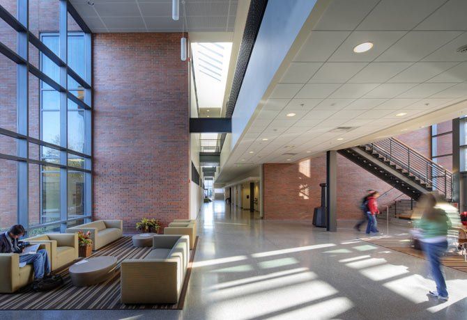 People are walking down a hallway in a building
