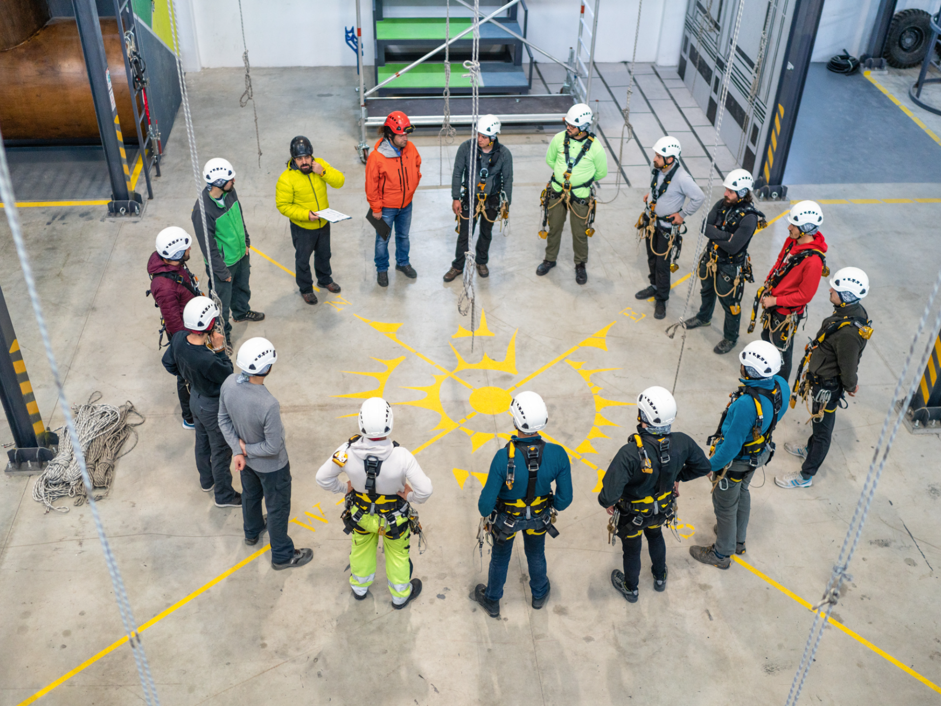 A group of people are standing in a circle in a building.