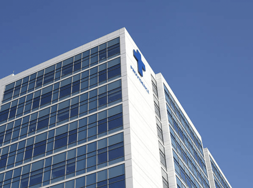 A tall building with a blue cross on the side