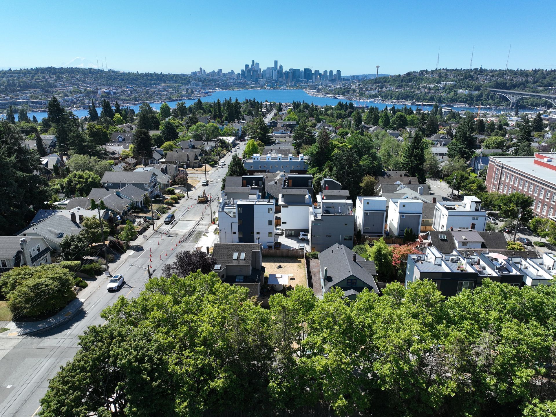 An aerial view of a residential area with a city in the background