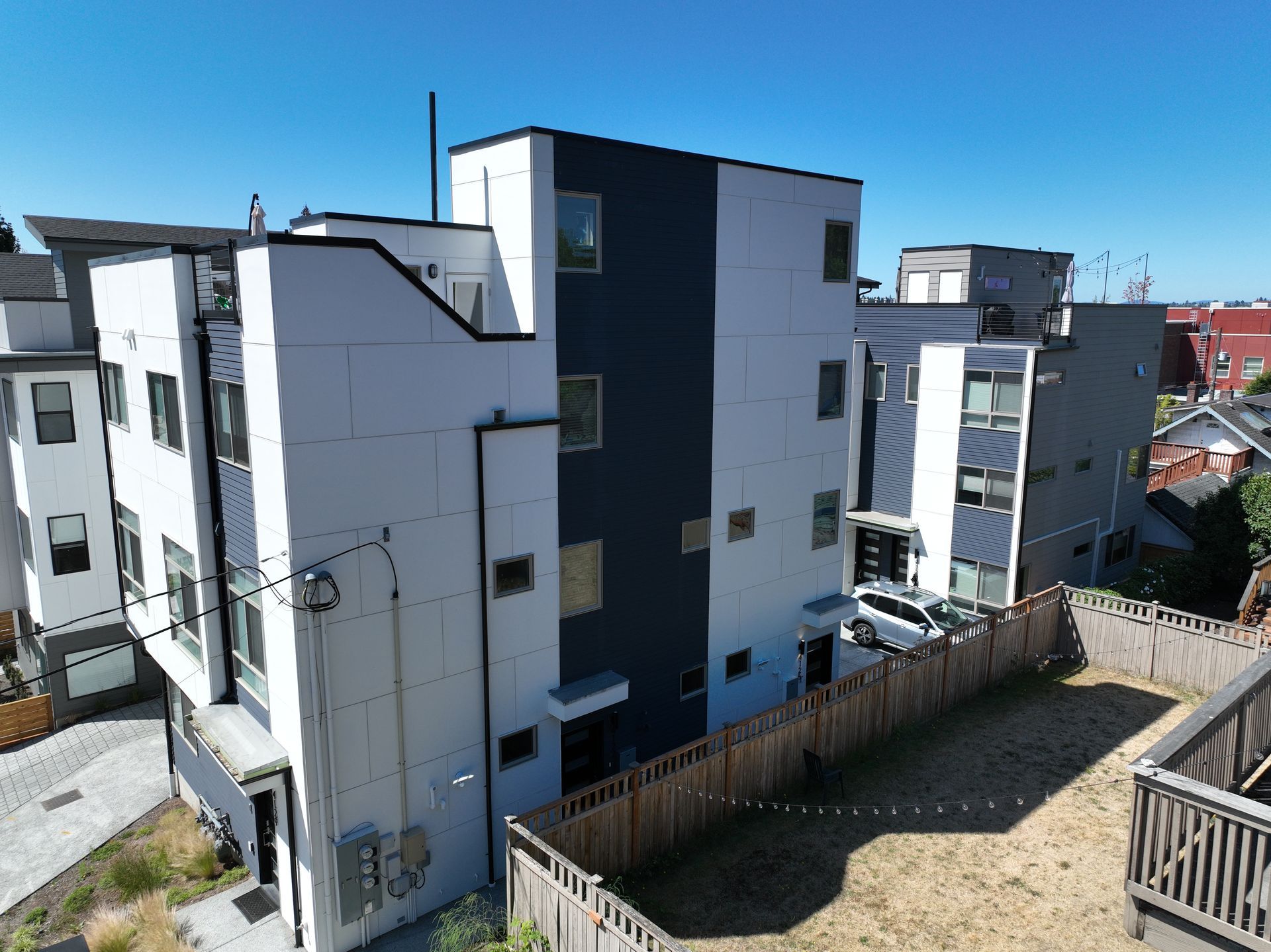 An aerial view of a building with a wooden fence around it