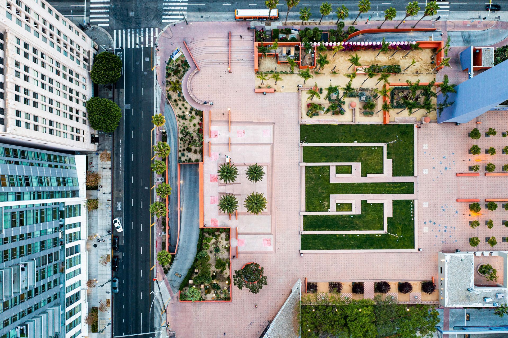 An aerial view of a city park surrounded by buildings and trees.