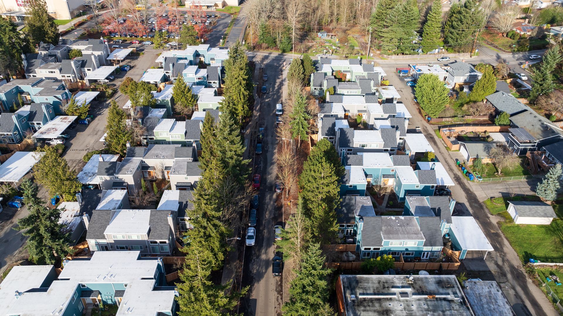 An aerial view of a residential area with lots of houses and trees.