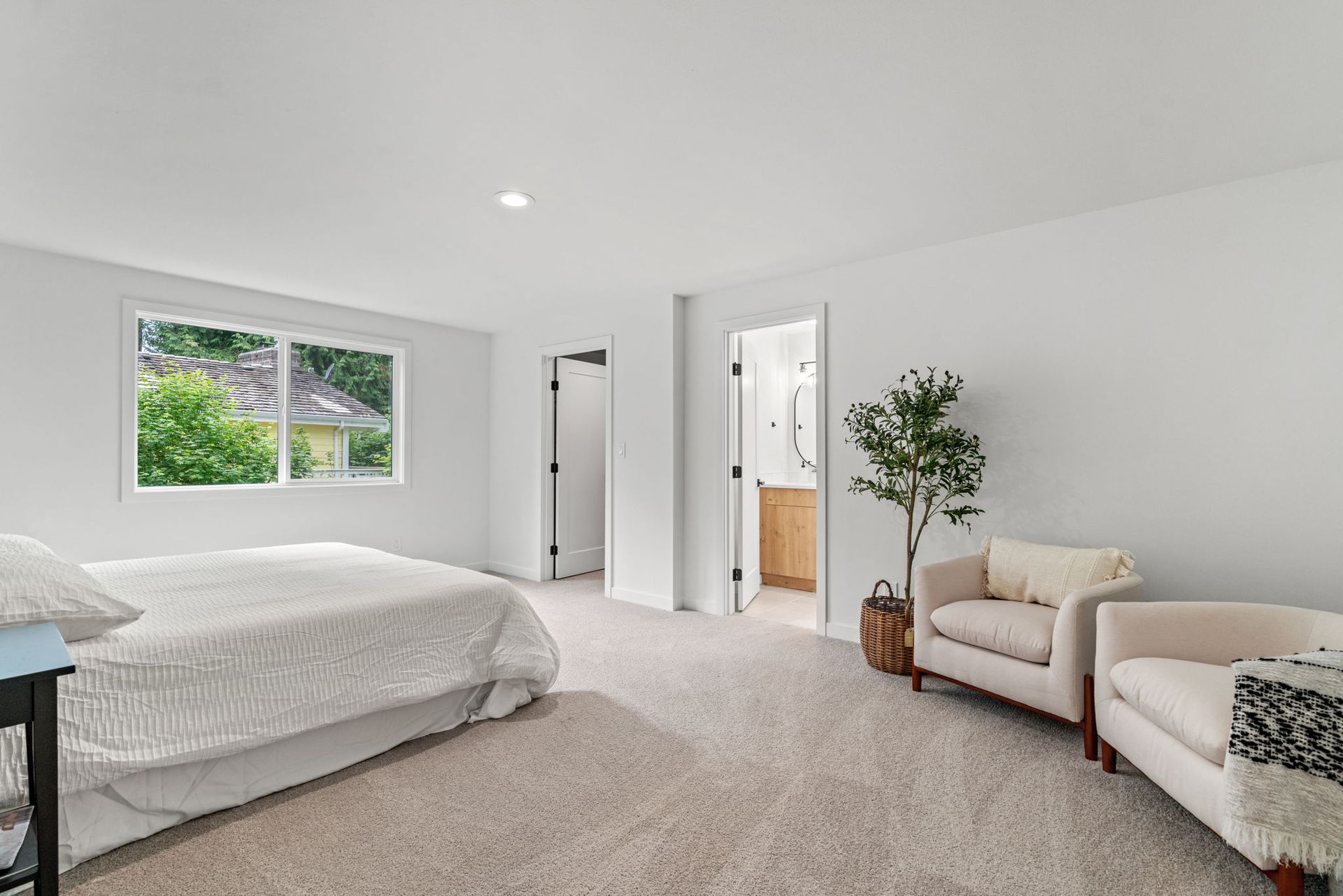 A bedroom with a bed , chair , and window.