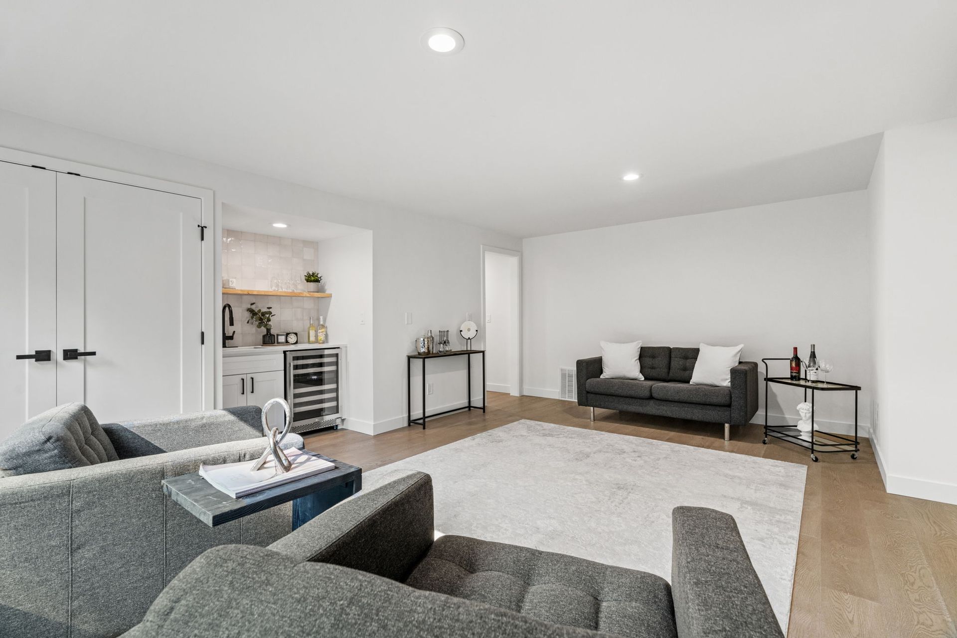 A living room with a couch , chairs , and a rug.