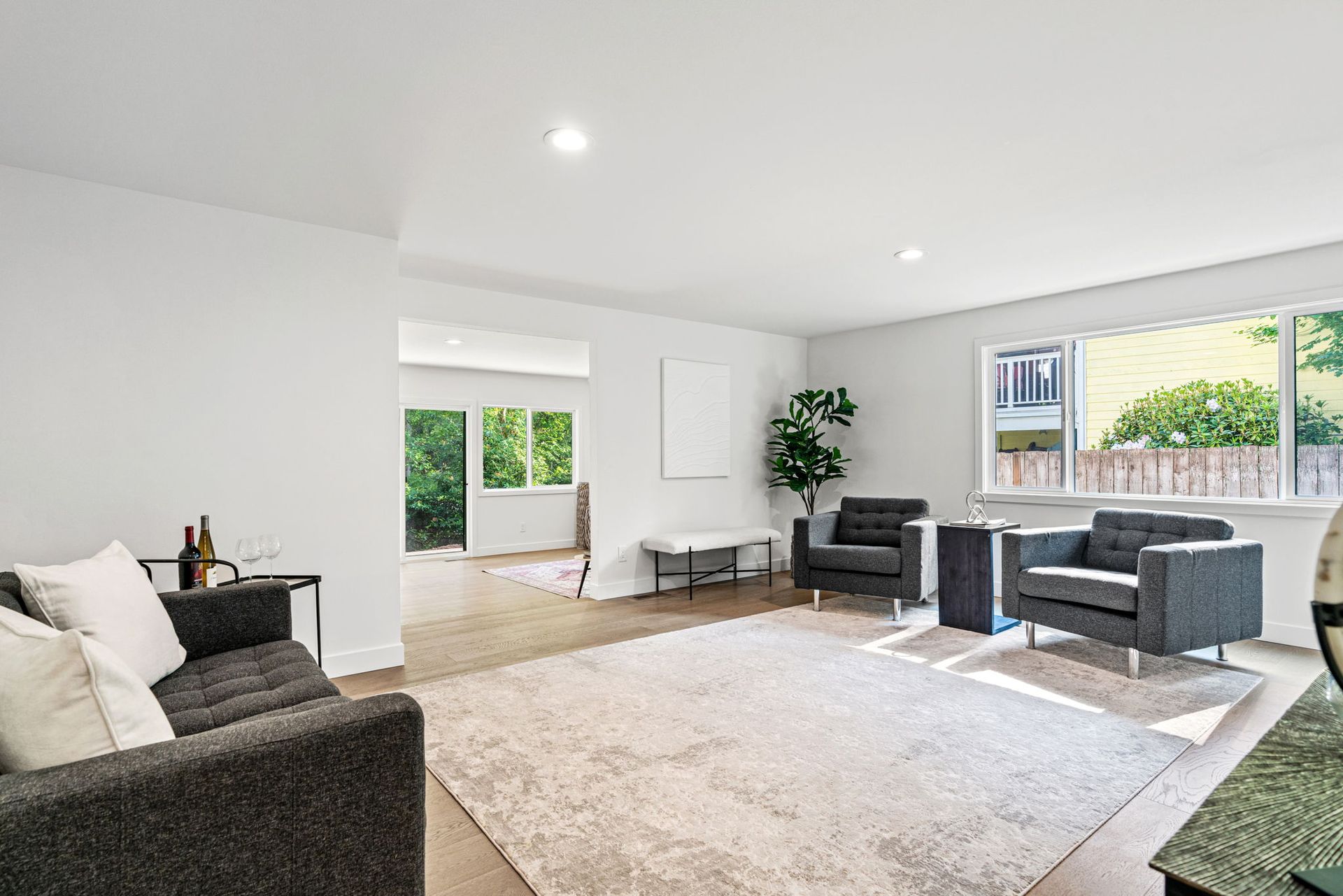 A living room with a couch , chairs , and a rug.
