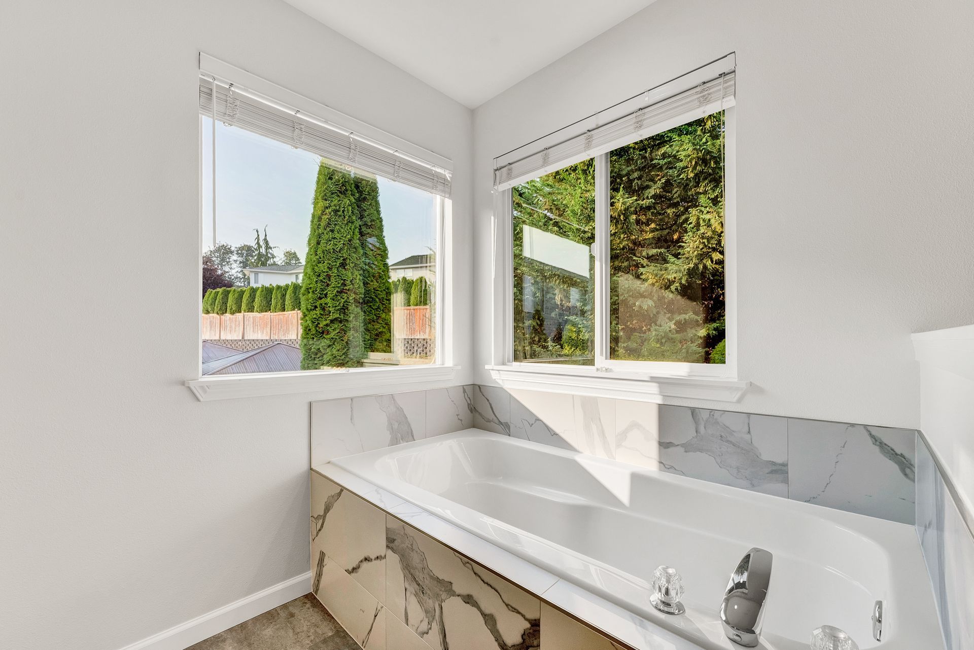 A bathroom with a bathtub and a window.