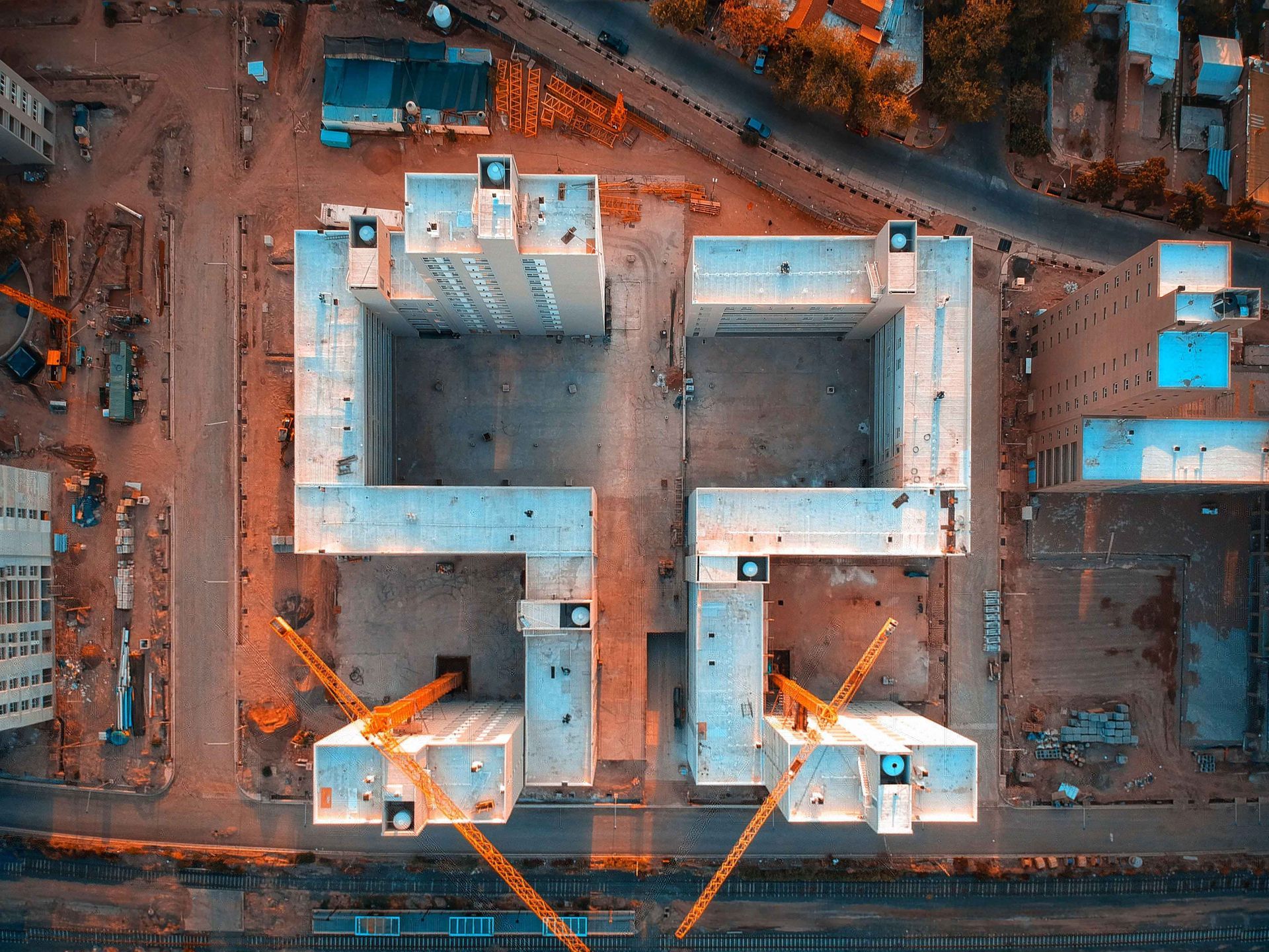 An aerial view of a building under construction in a city.