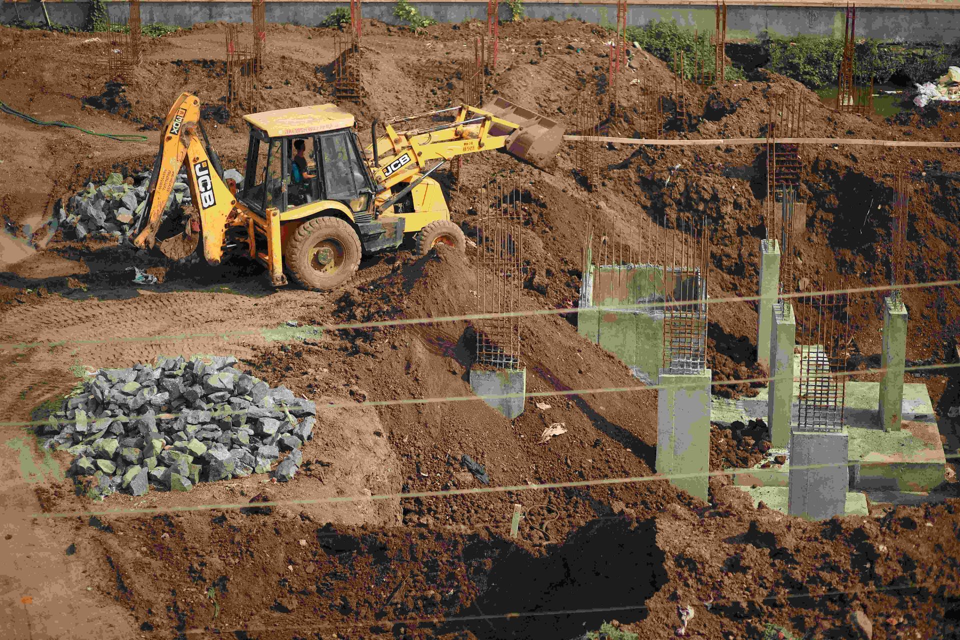 A yellow bulldozer is moving dirt on a construction site.