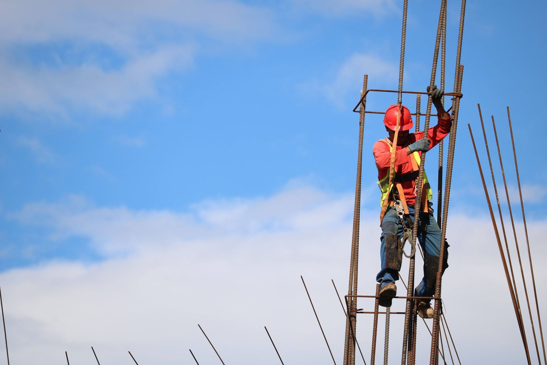 A construction worker is working on a metal structure