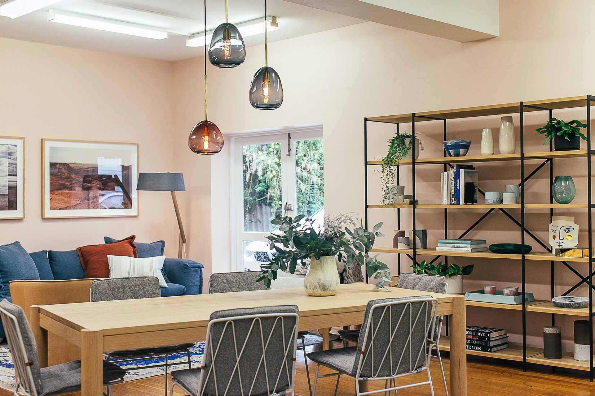 A living room with a table and chairs and a couch.