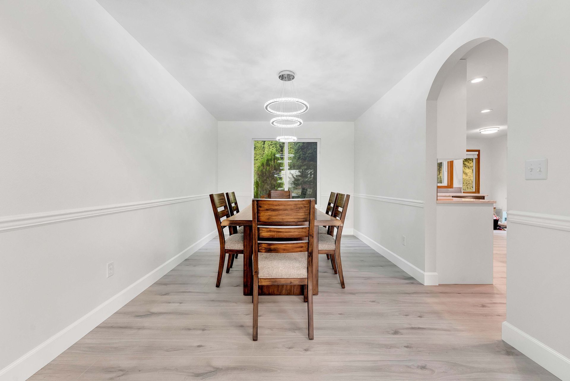 A dining room with a table and chairs in a house.