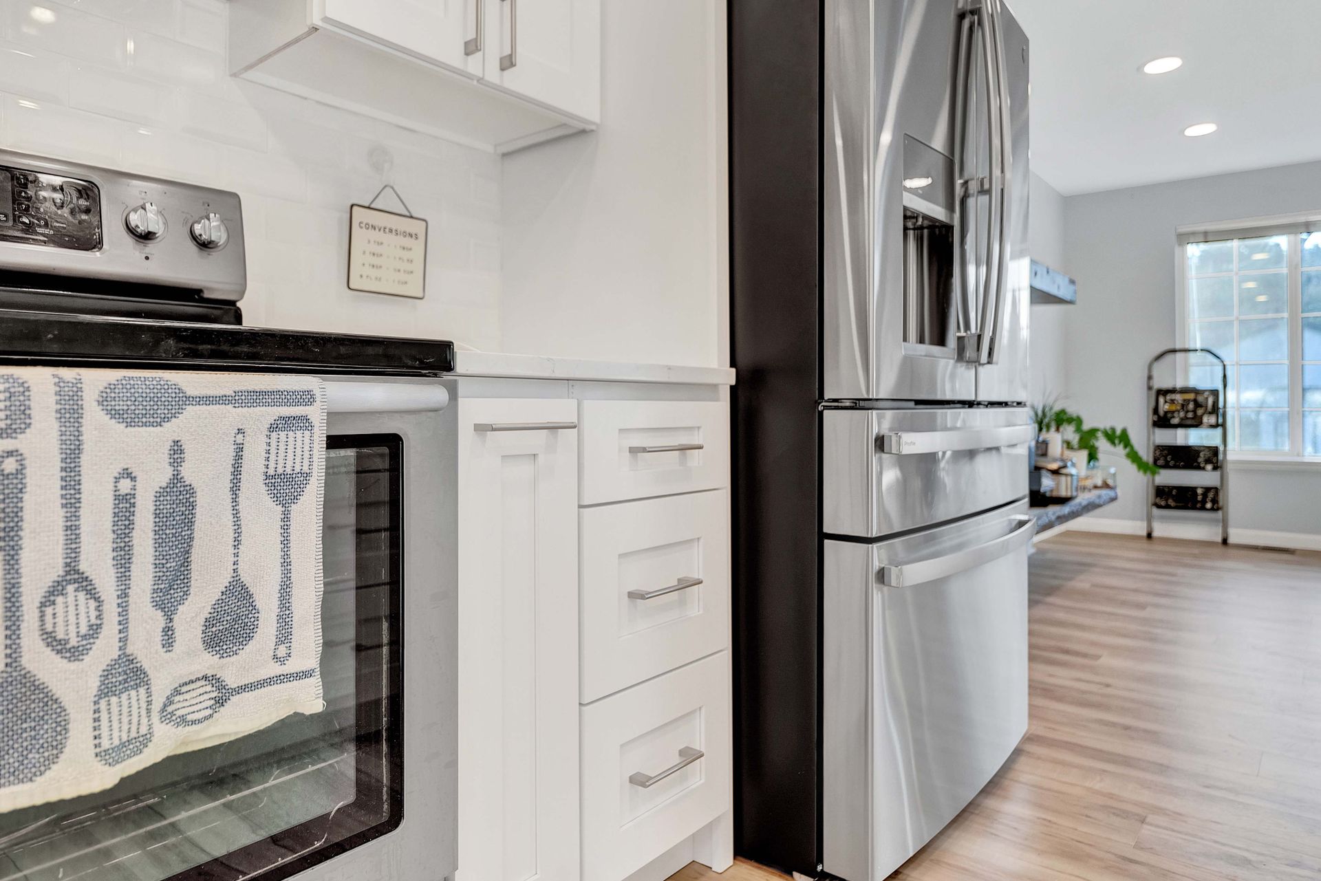 A kitchen with a stove , refrigerator , and oven.