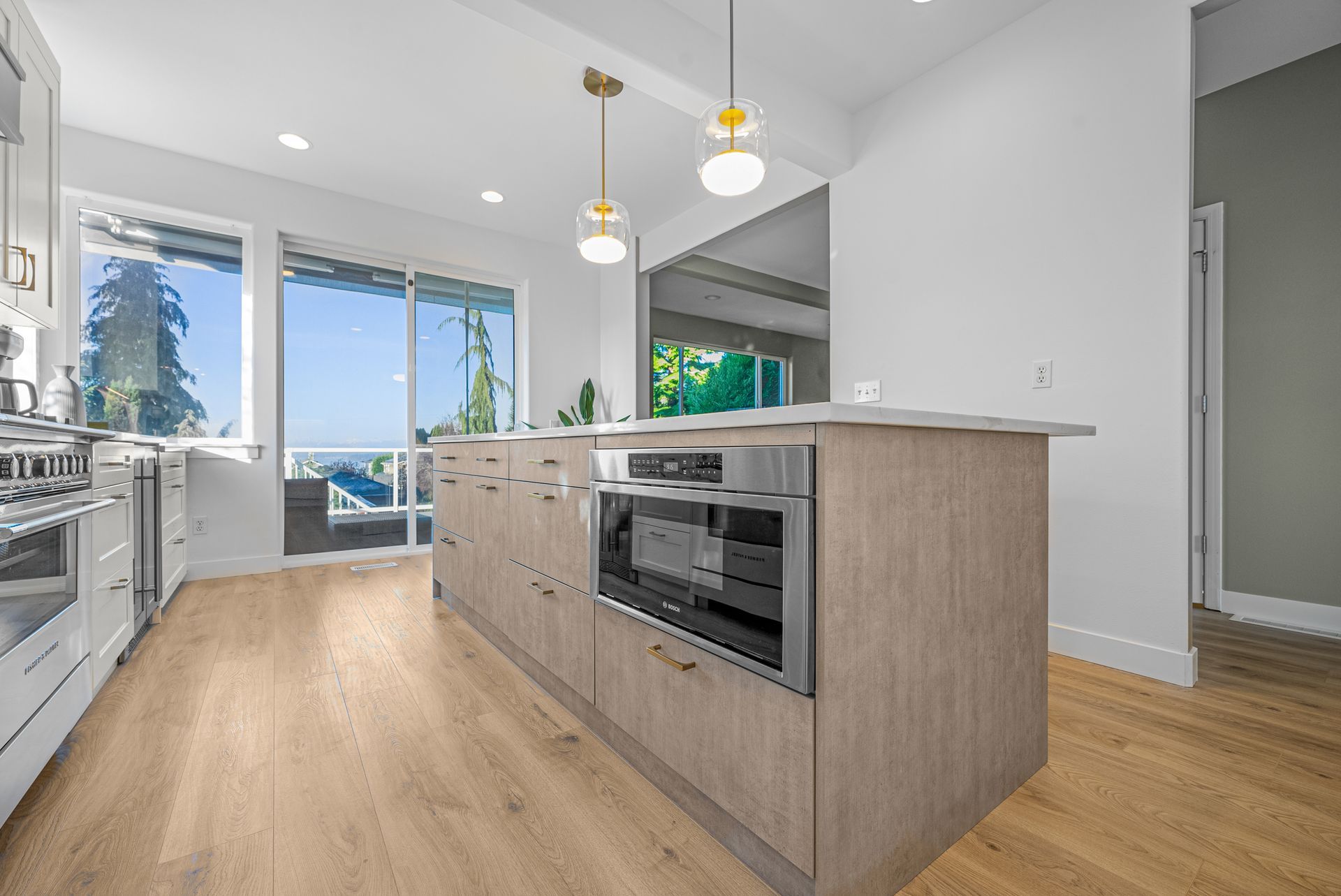 A kitchen with a large island and stainless steel appliances.