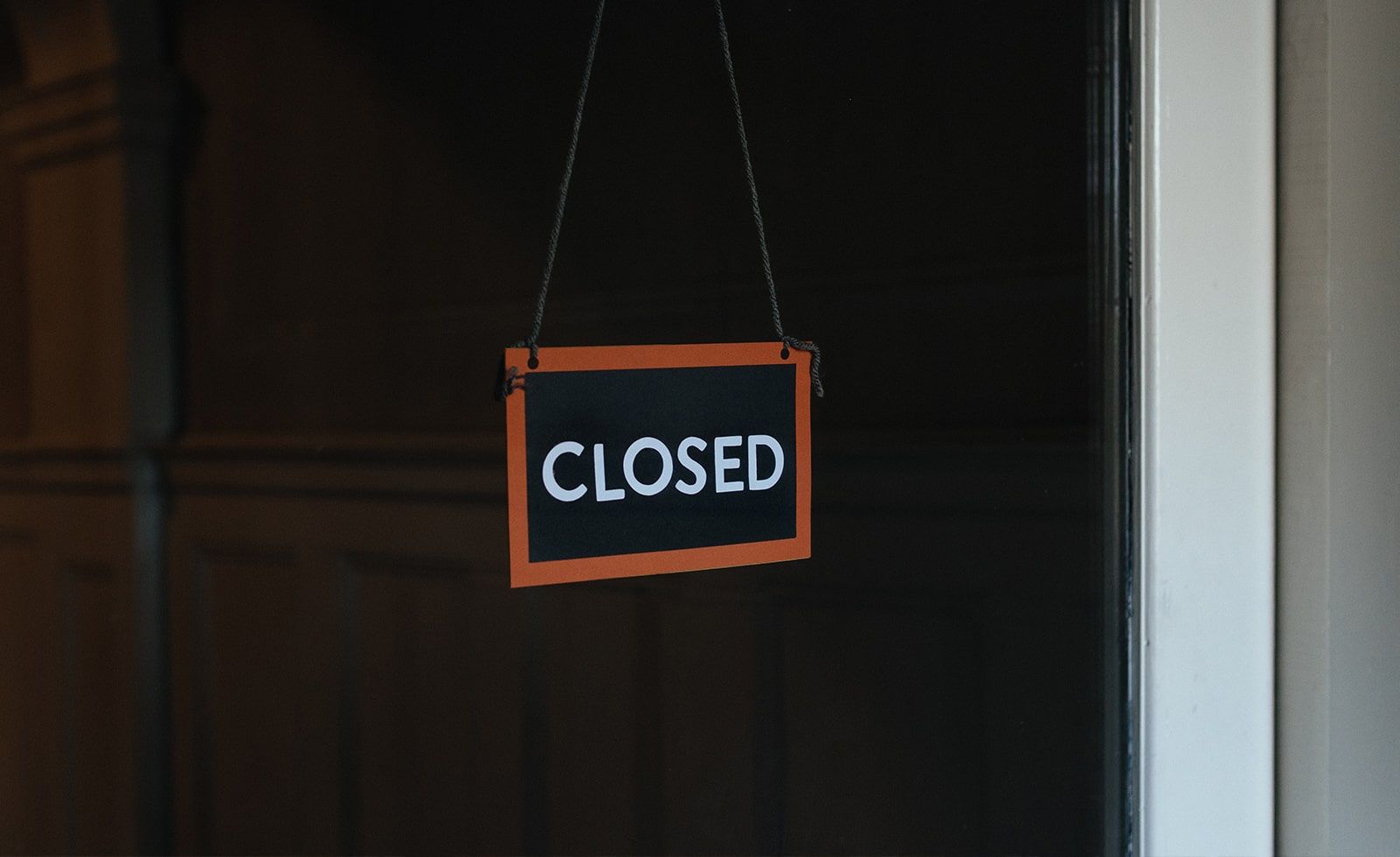 Closure of business A closed sign is hanging on a window.