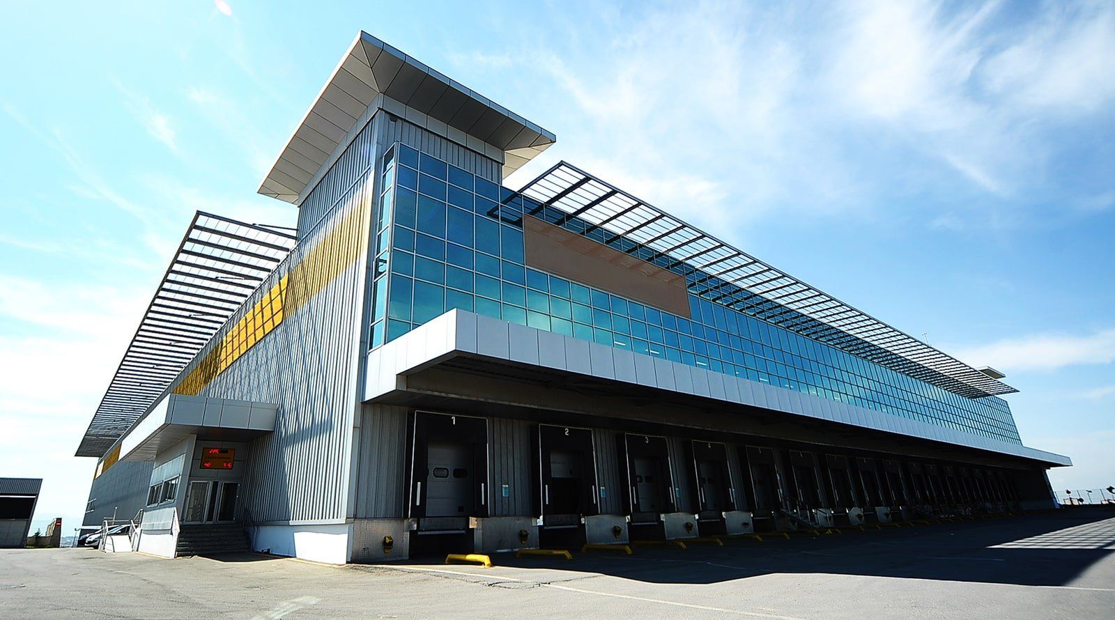 Steel built building A large building with a lot of windows and doors