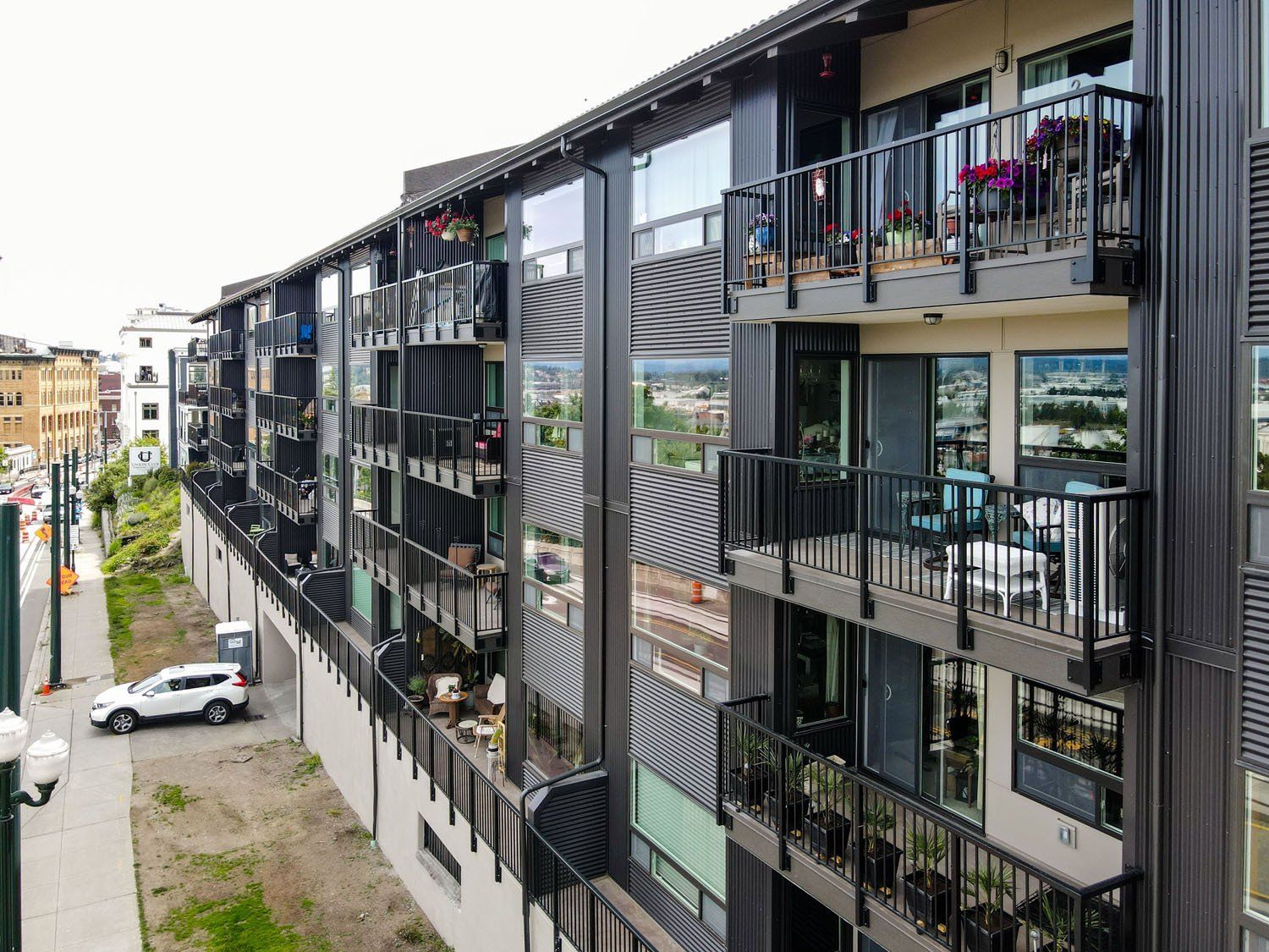 A large apartment building with lots of balconies and windows.