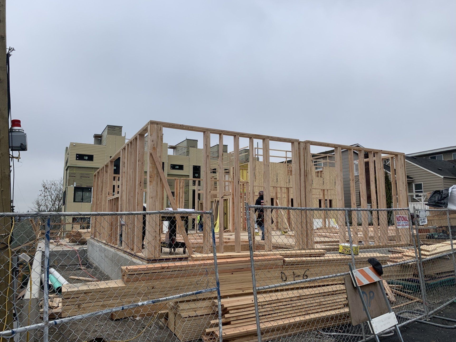 A building under construction with a fence around it.