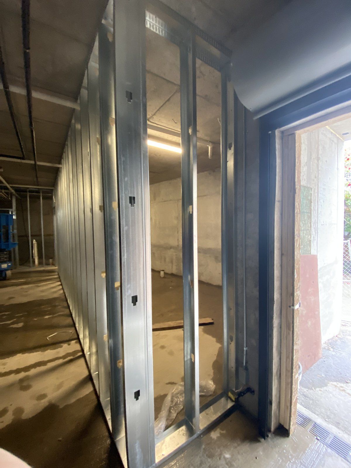 A room with a lot of metal walls and a door.