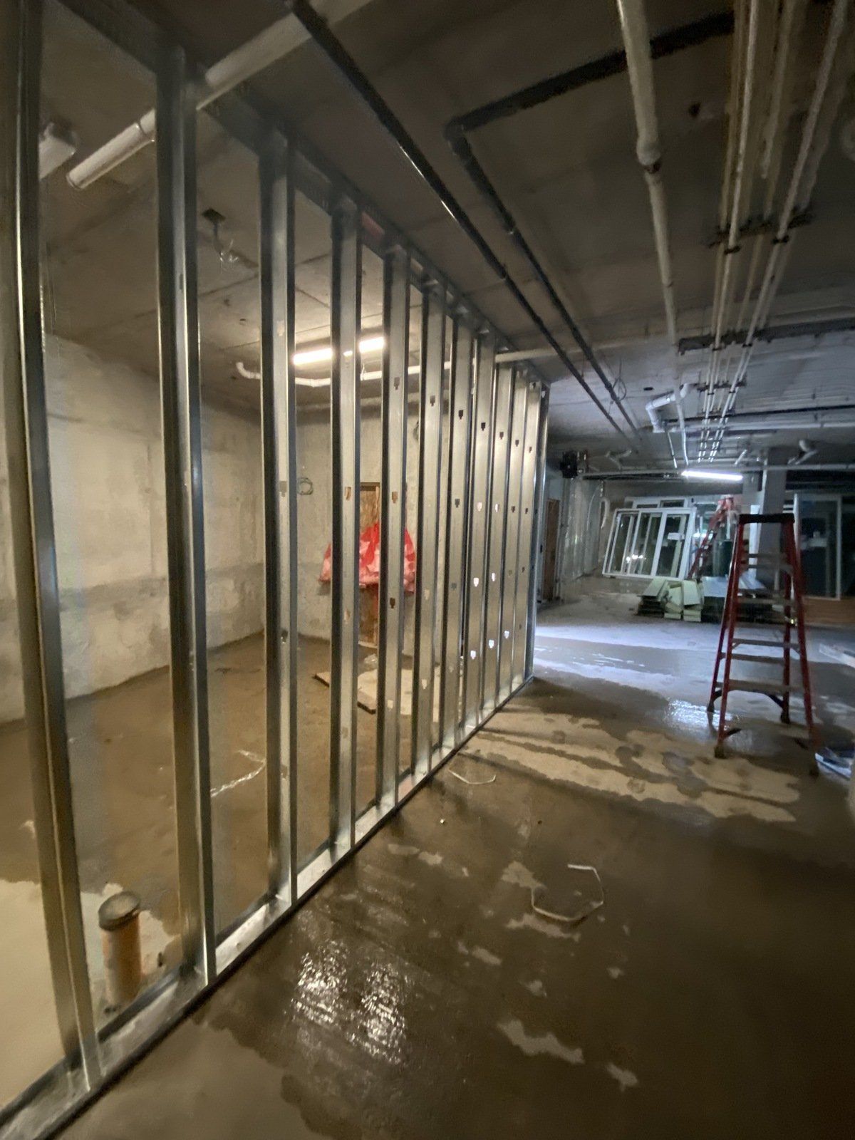 A room with a lot of metal walls and a ladder.