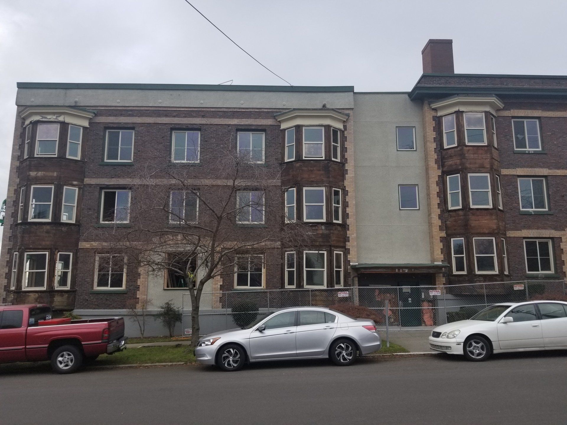 A brick building with cars parked in front of it