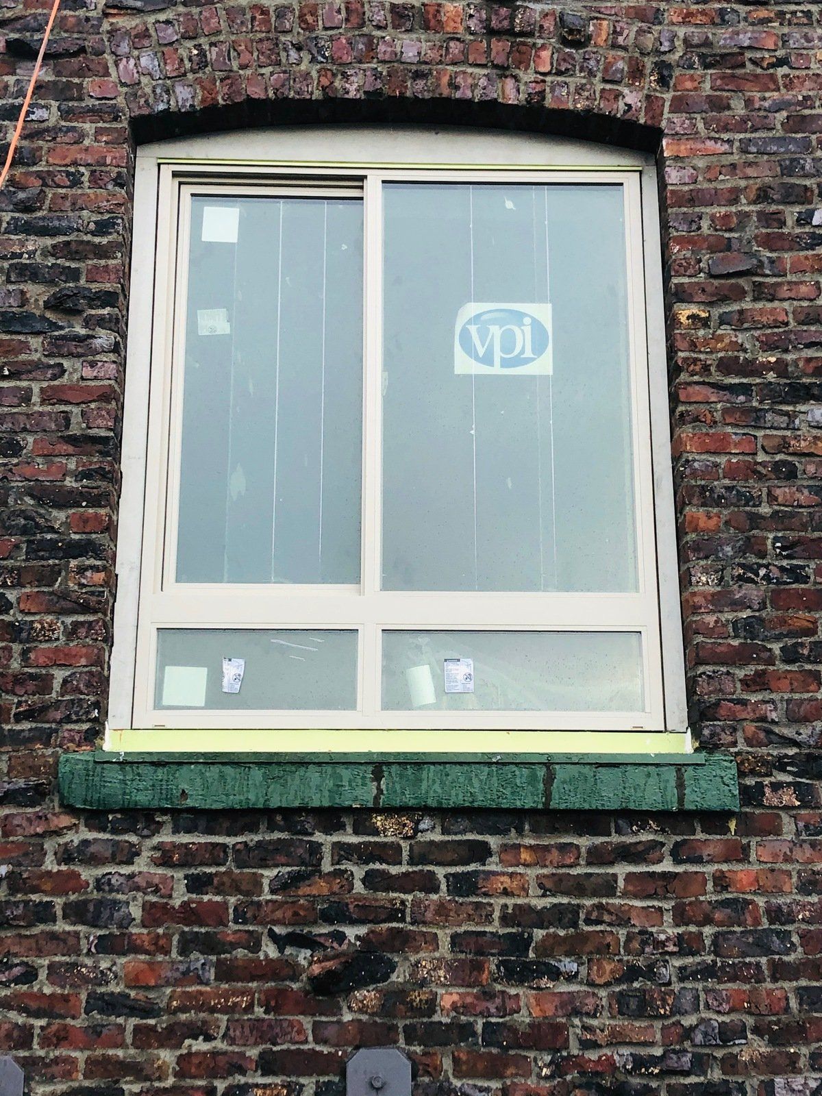 A brick building with a window that says vpi on it