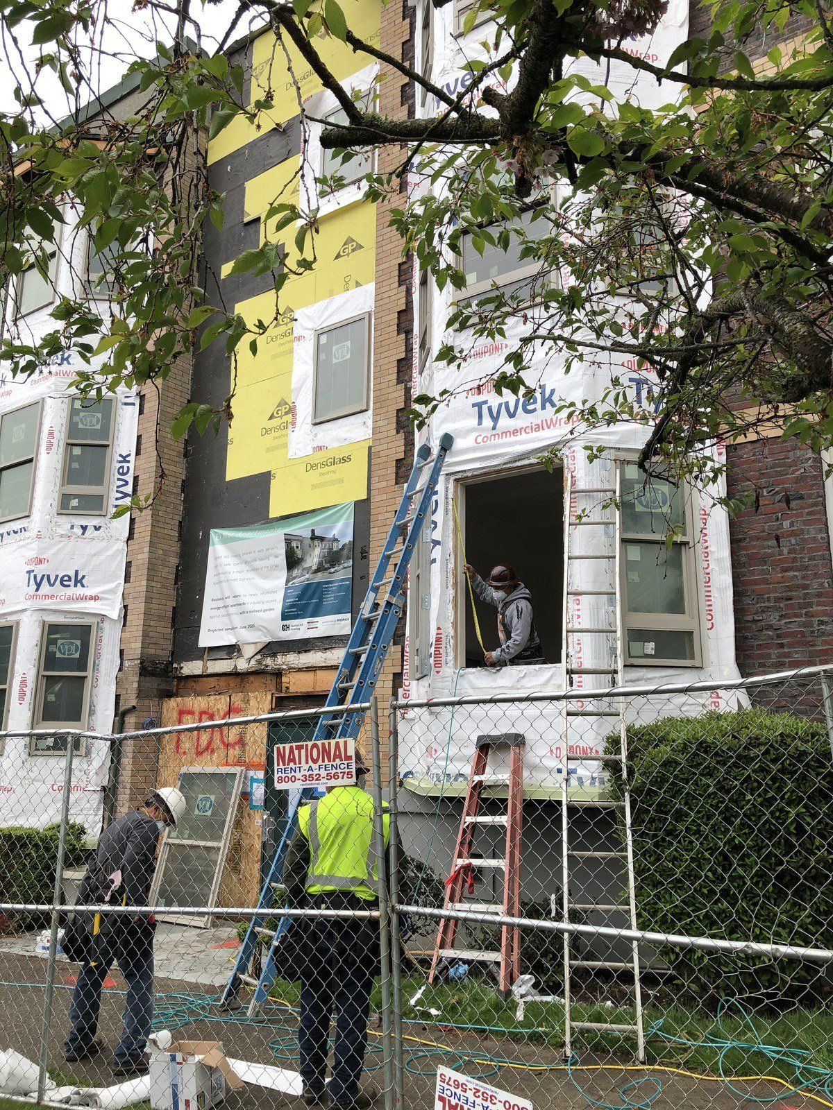 A group of construction workers are working on a building.