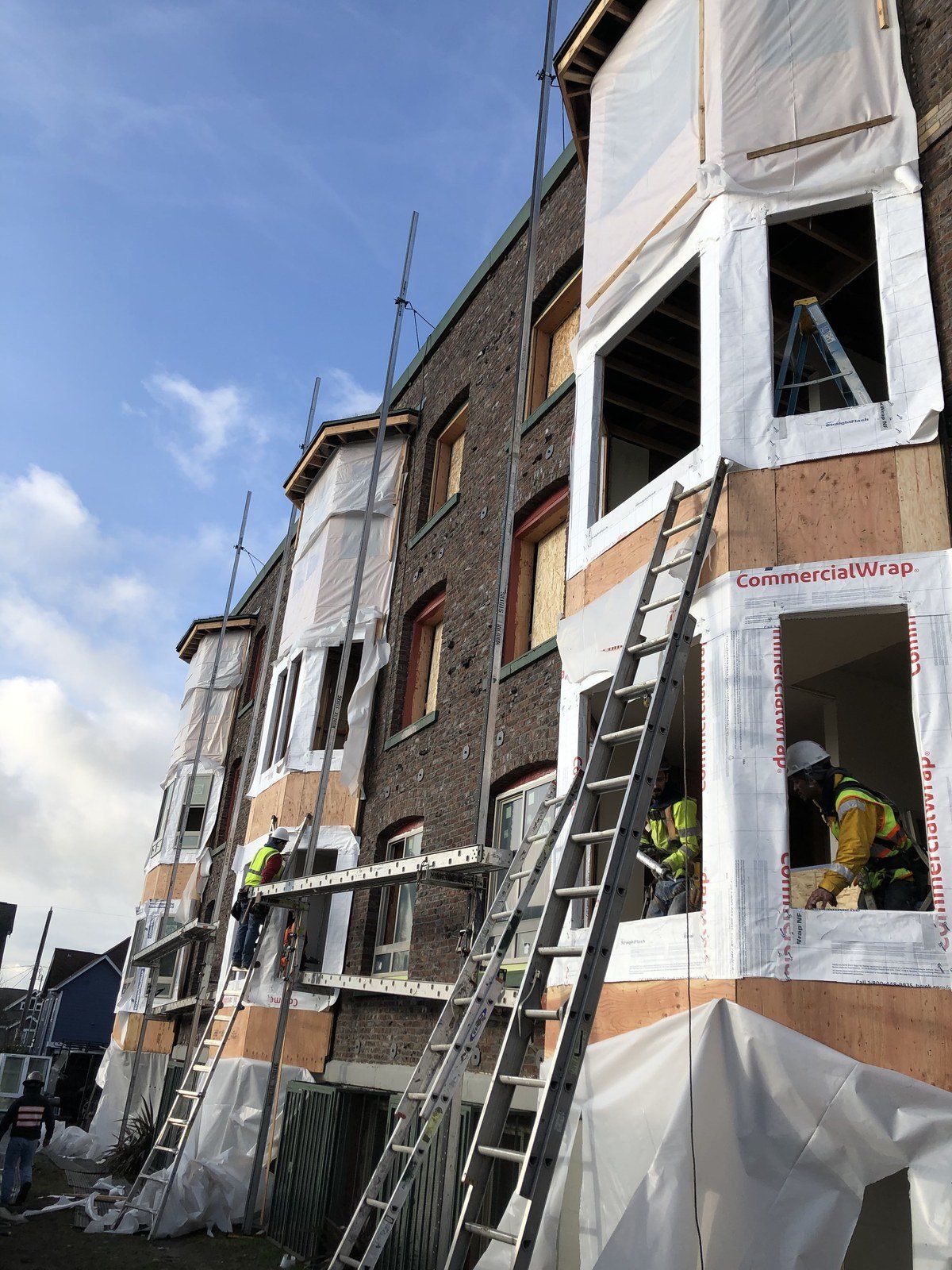 A group of construction workers are working on a building.