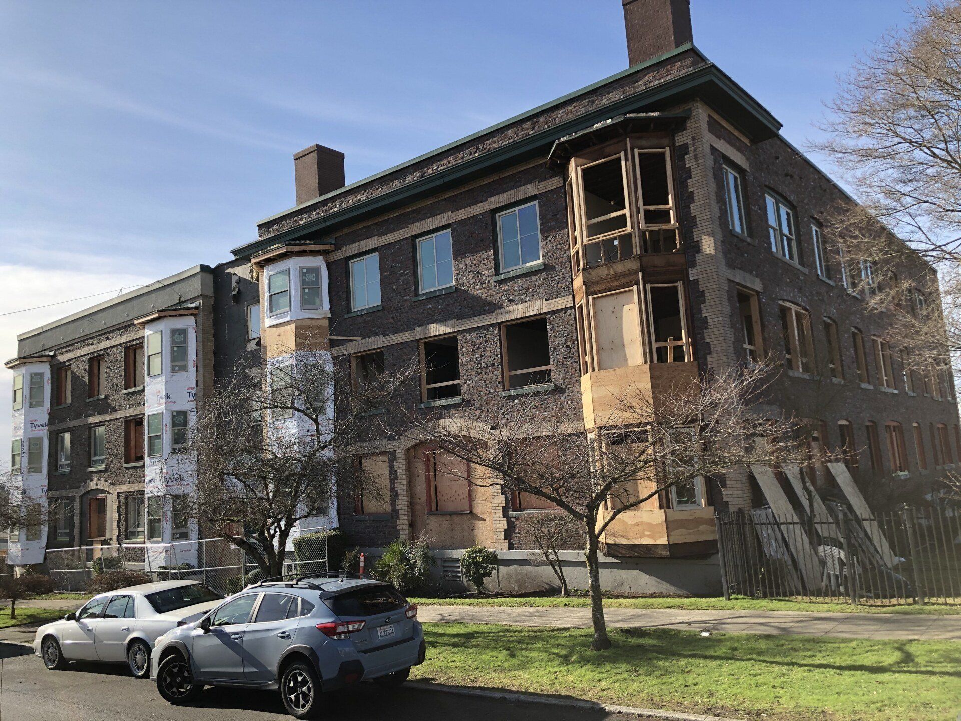A large building with cars parked in front of it.