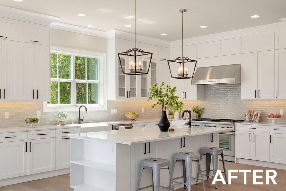A kitchen with white cabinets , stainless steel appliances , and a large island.
