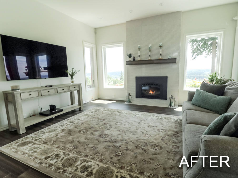 A living room with a couch , fireplace , television and rug.