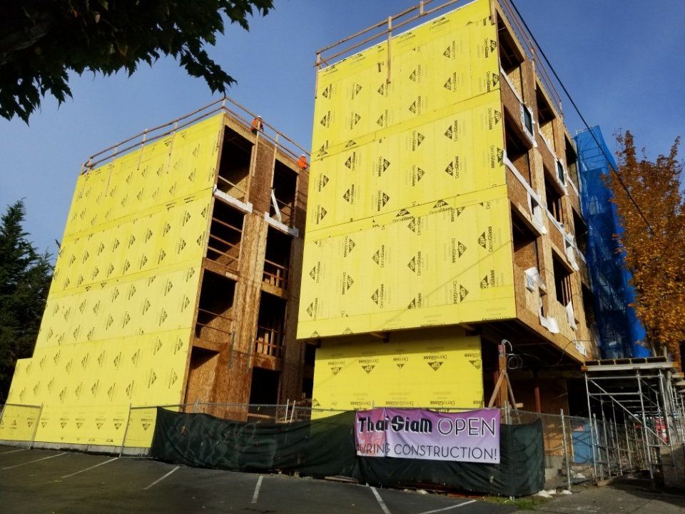 A building under construction with a sign that says the site is open construction