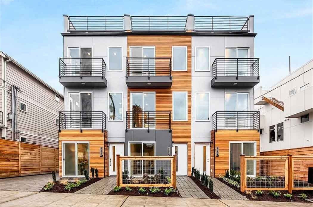 A modern apartment building with a lot of windows and balconies.