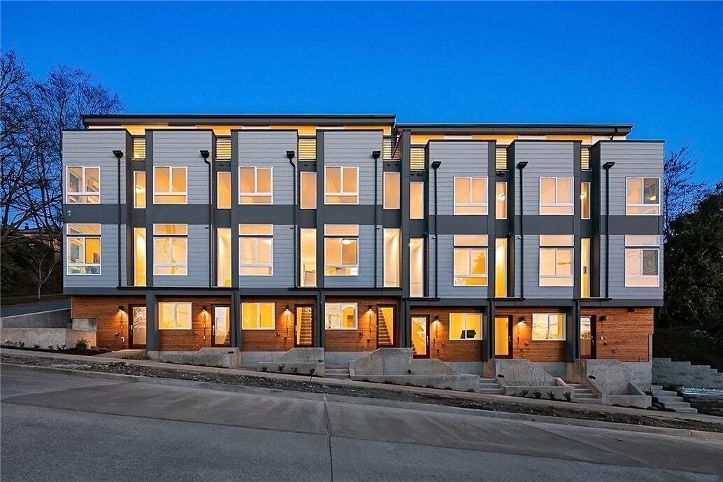 A large building with a lot of windows is lit up at night.