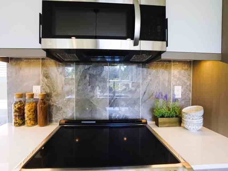 A kitchen with a stove top oven and a microwave.