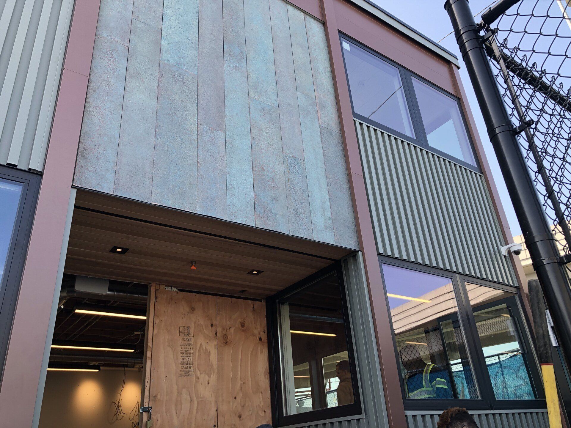 A building with a lot of windows and a fence in front of it