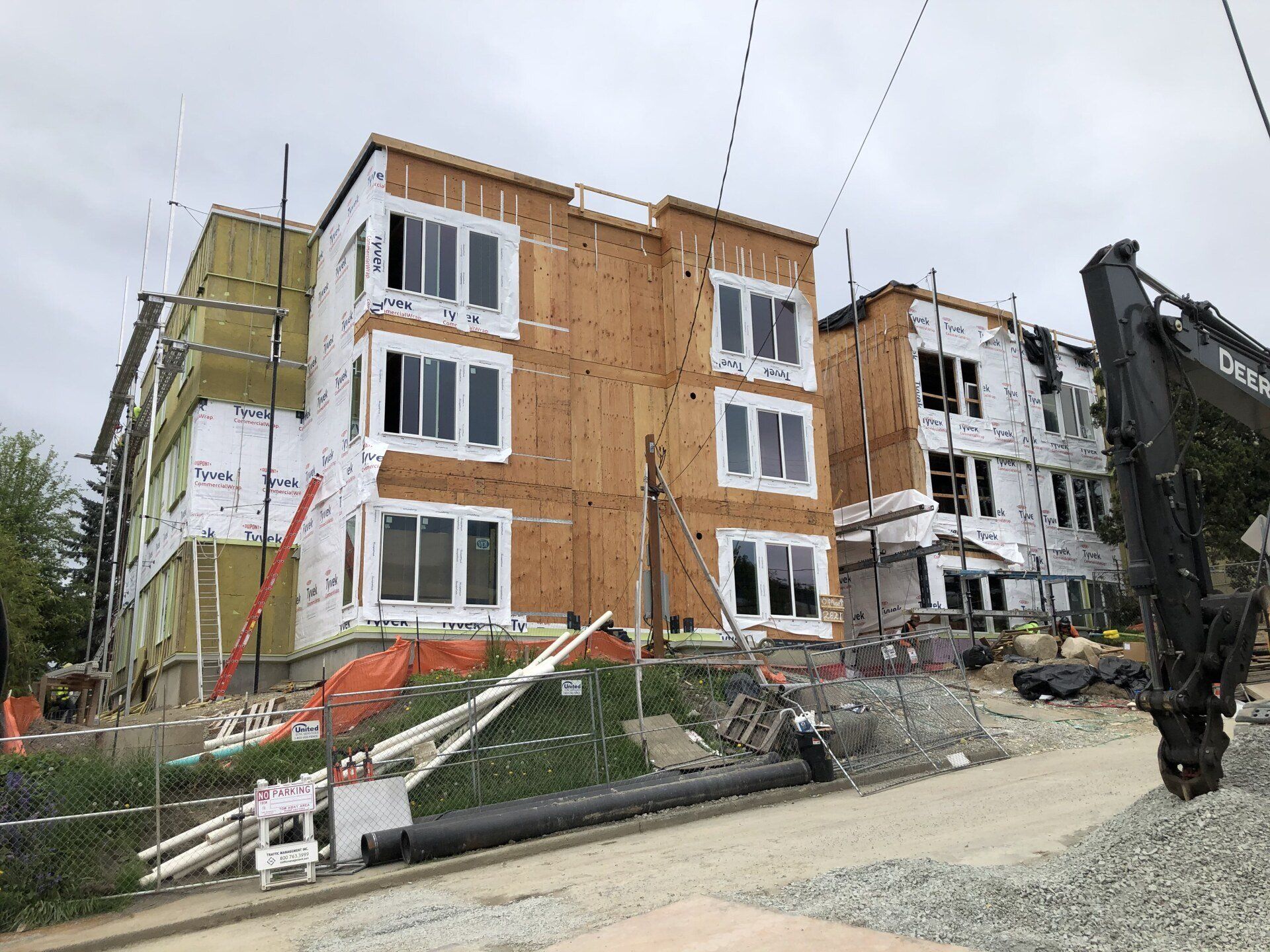 A large building under construction with a crane in front of it.