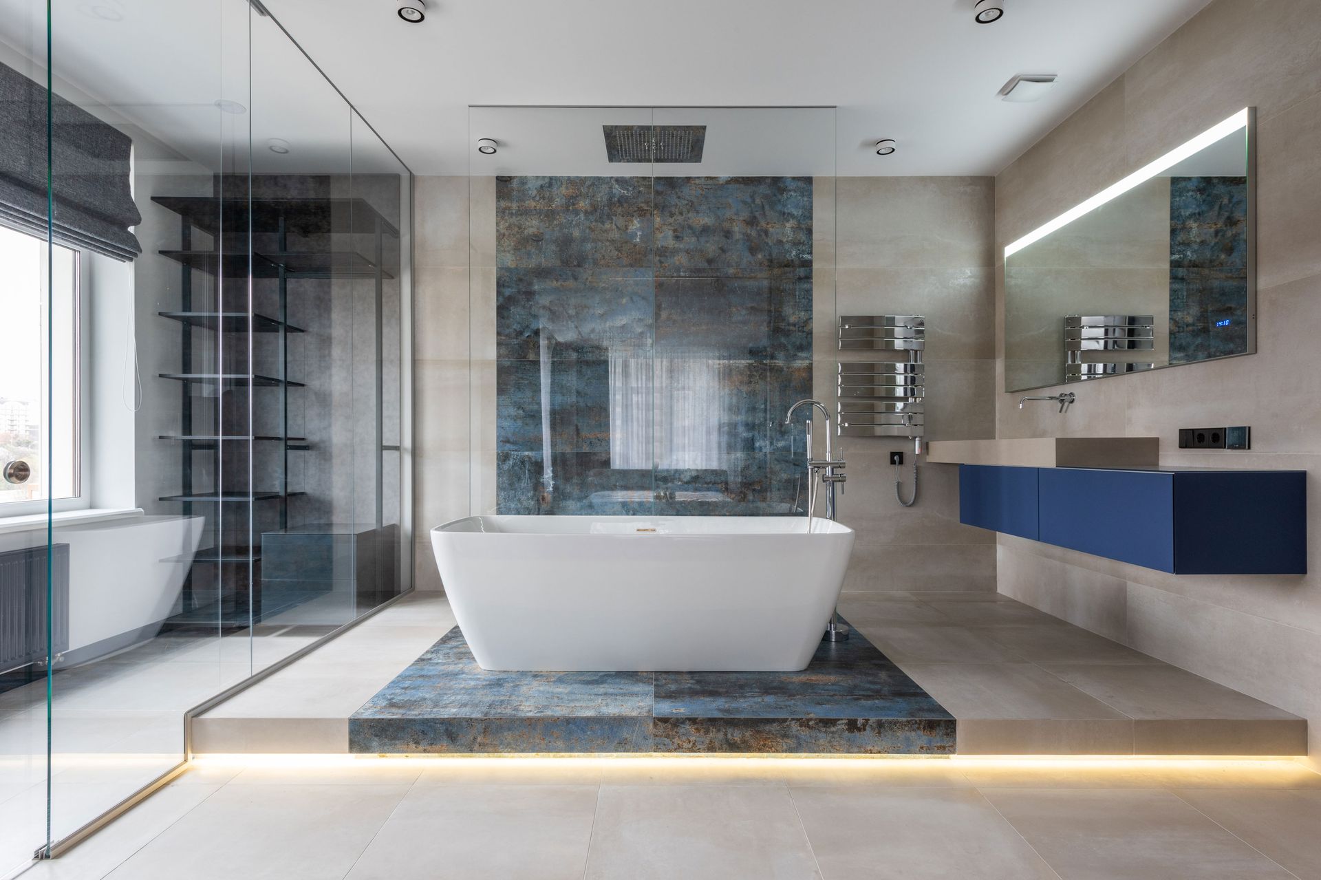 A bathroom with a bathtub , sink , shower and mirror.