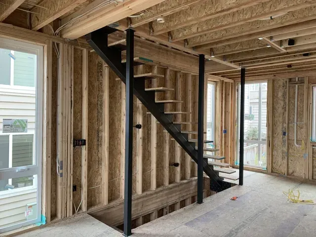 A staircase is being built in a house under construction.