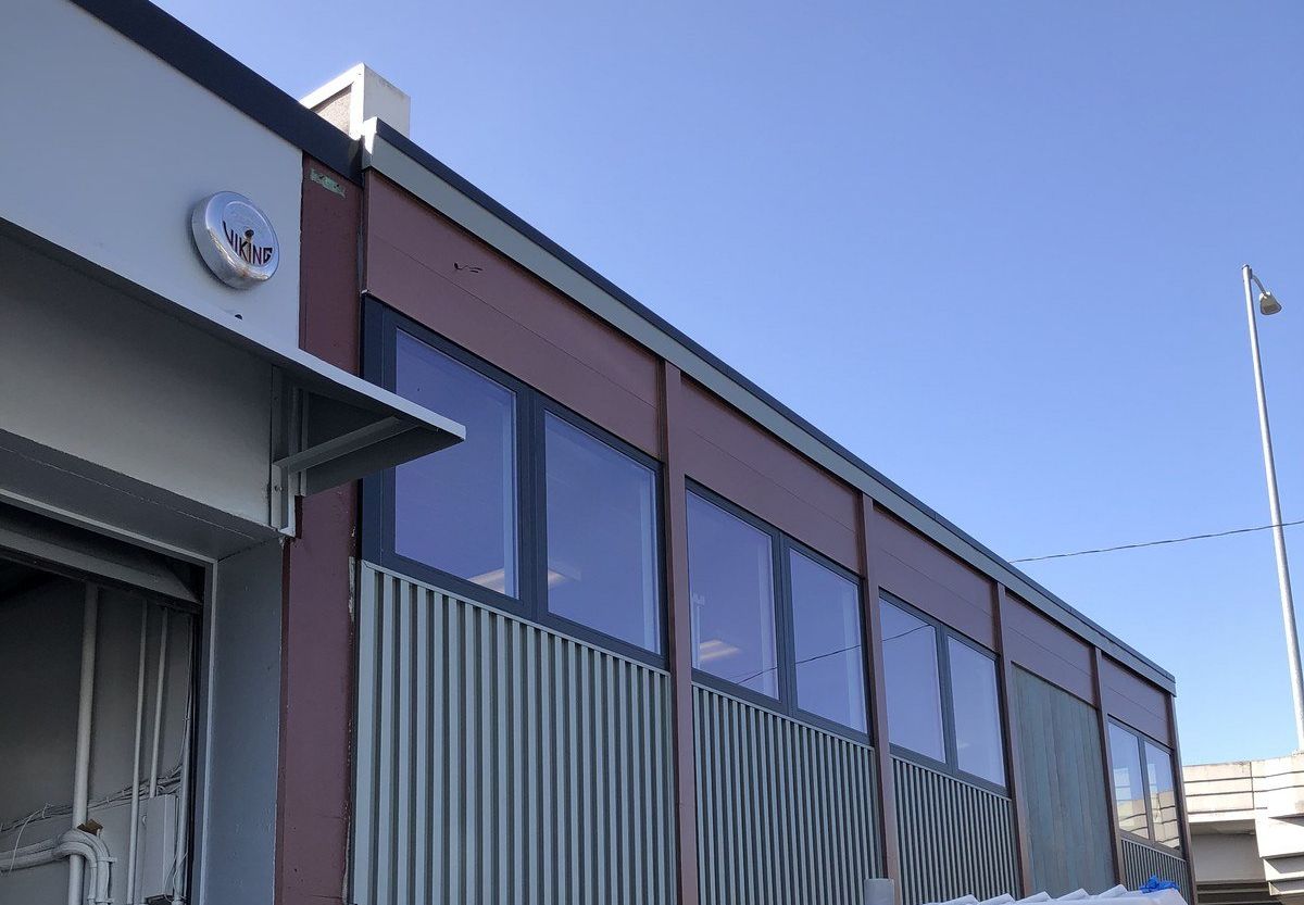 A building with a lot of windows and a blue sky in the background