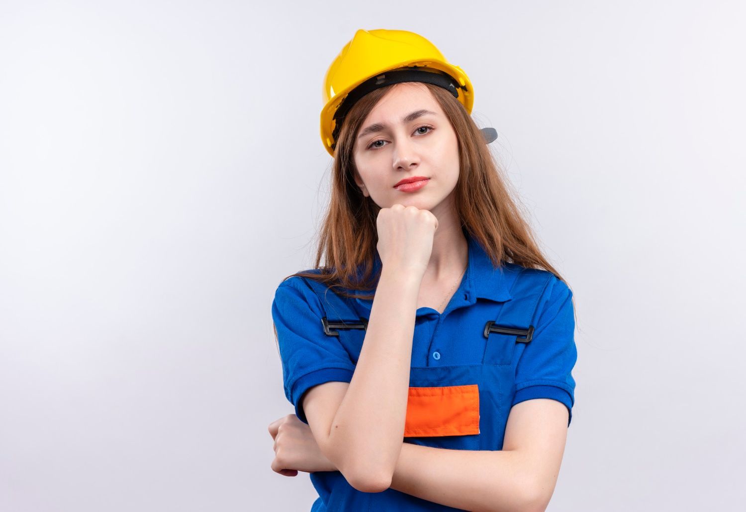 The woman is wearing a hard hat and a blue shirt.