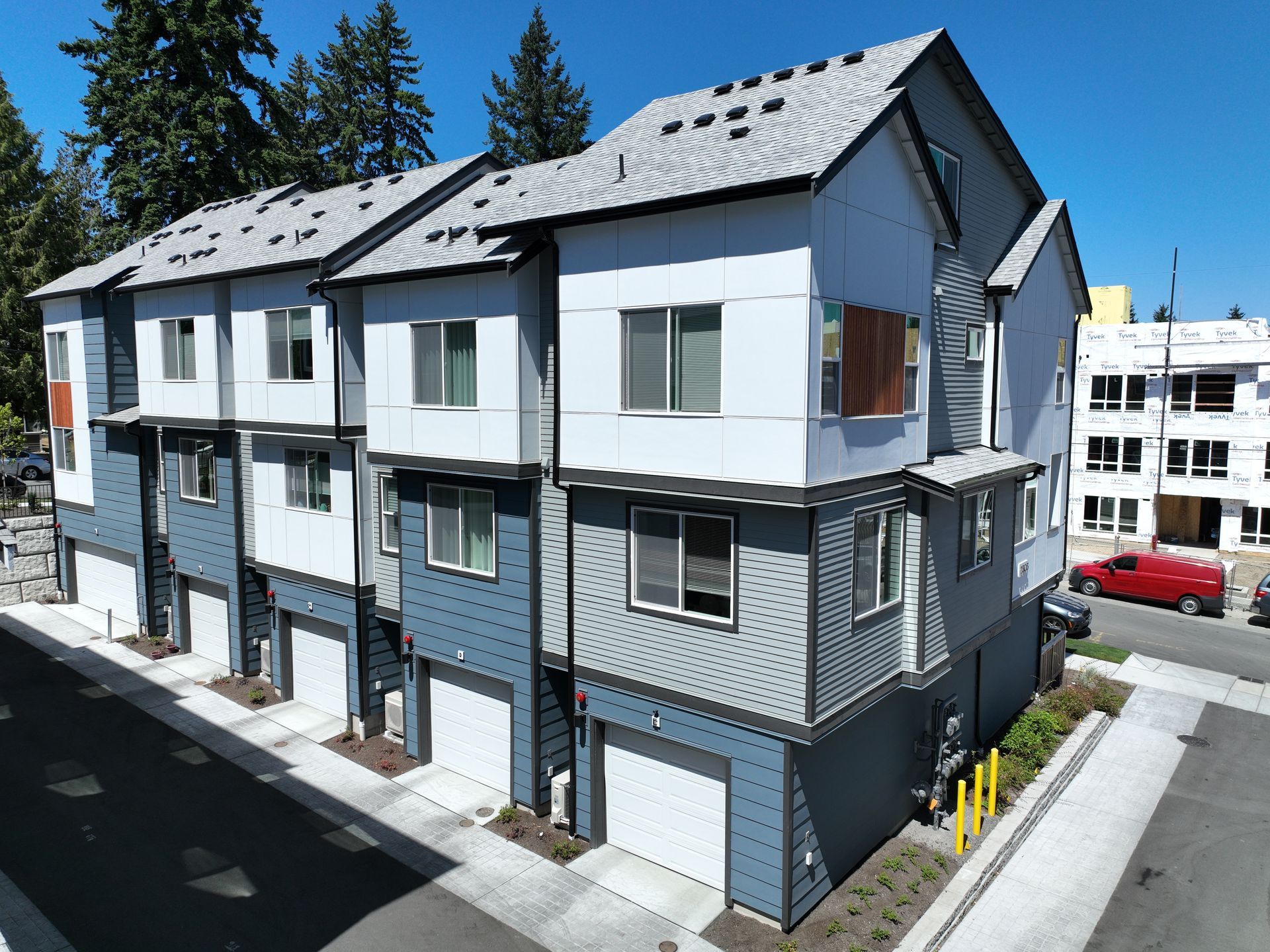 A row of apartment buildings with a red truck parked in front of them