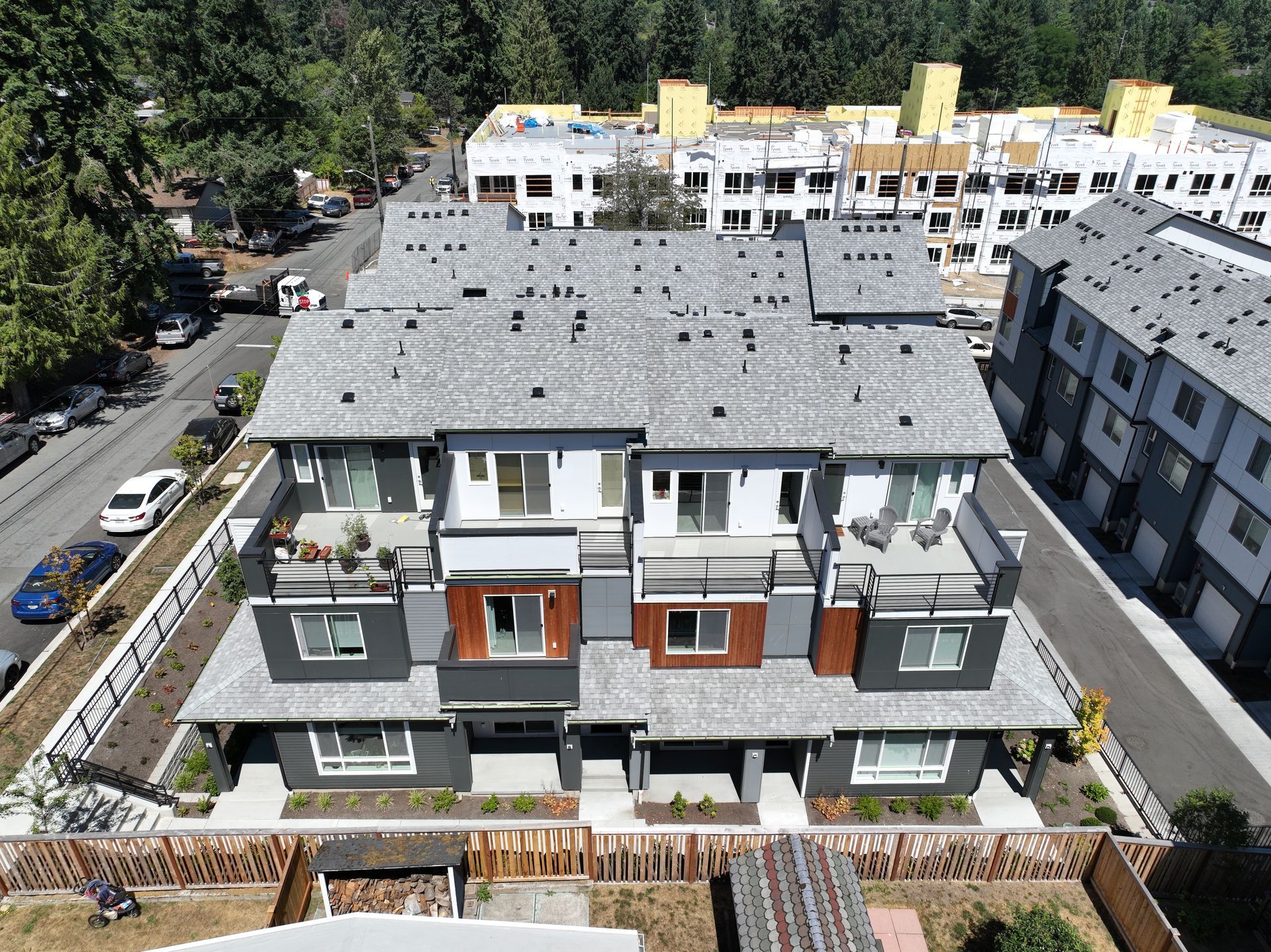 An aerial view of a row of apartment buildings surrounded by trees.