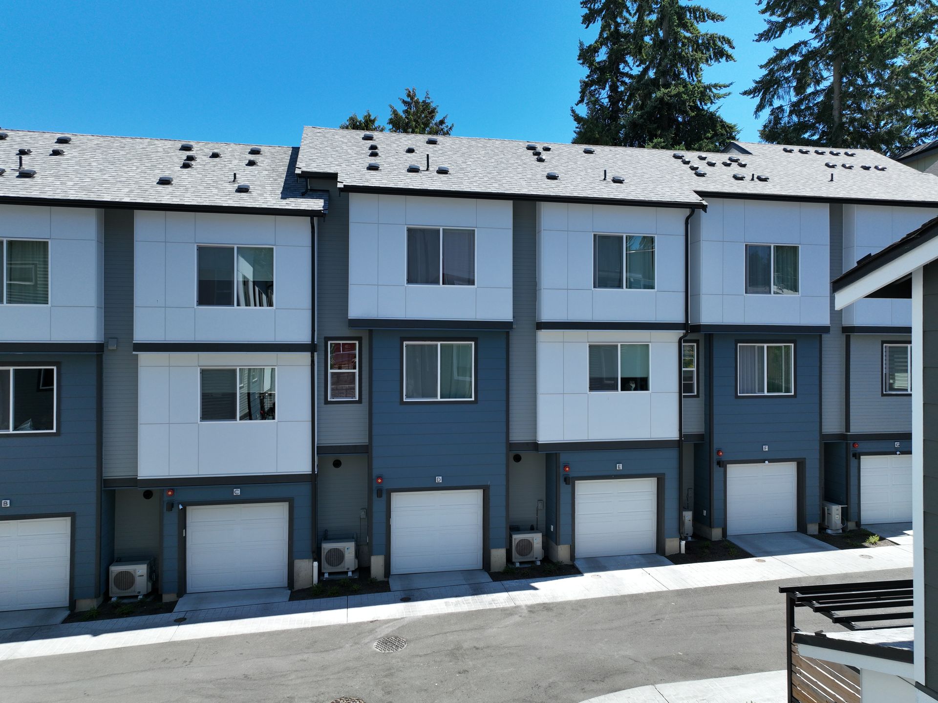 A row of apartment buildings with white garage doors