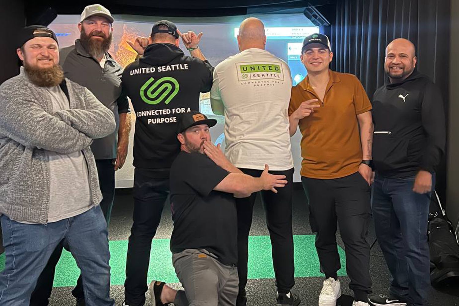 A group of men are posing for a picture together in a room.