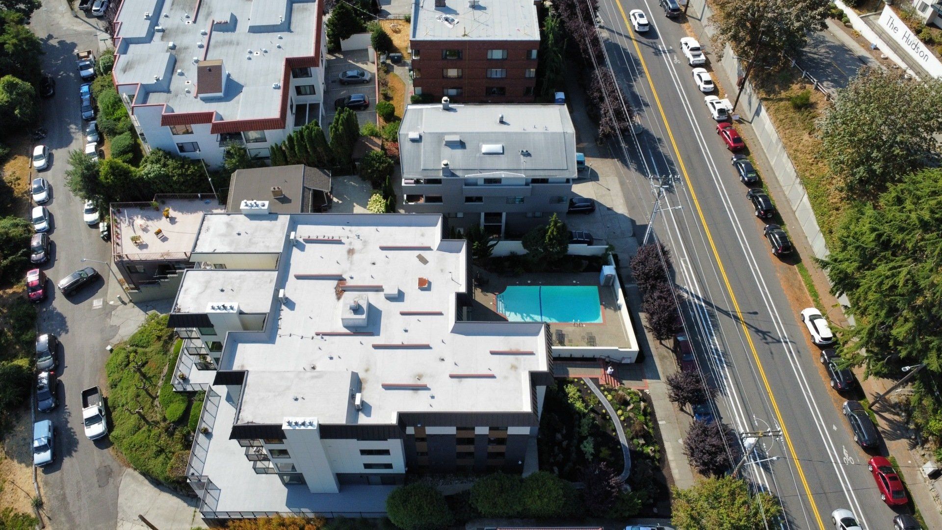 An aerial view of a residential area with a swimming pool
