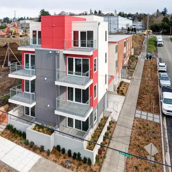 An aerial view of a red and white apartment building