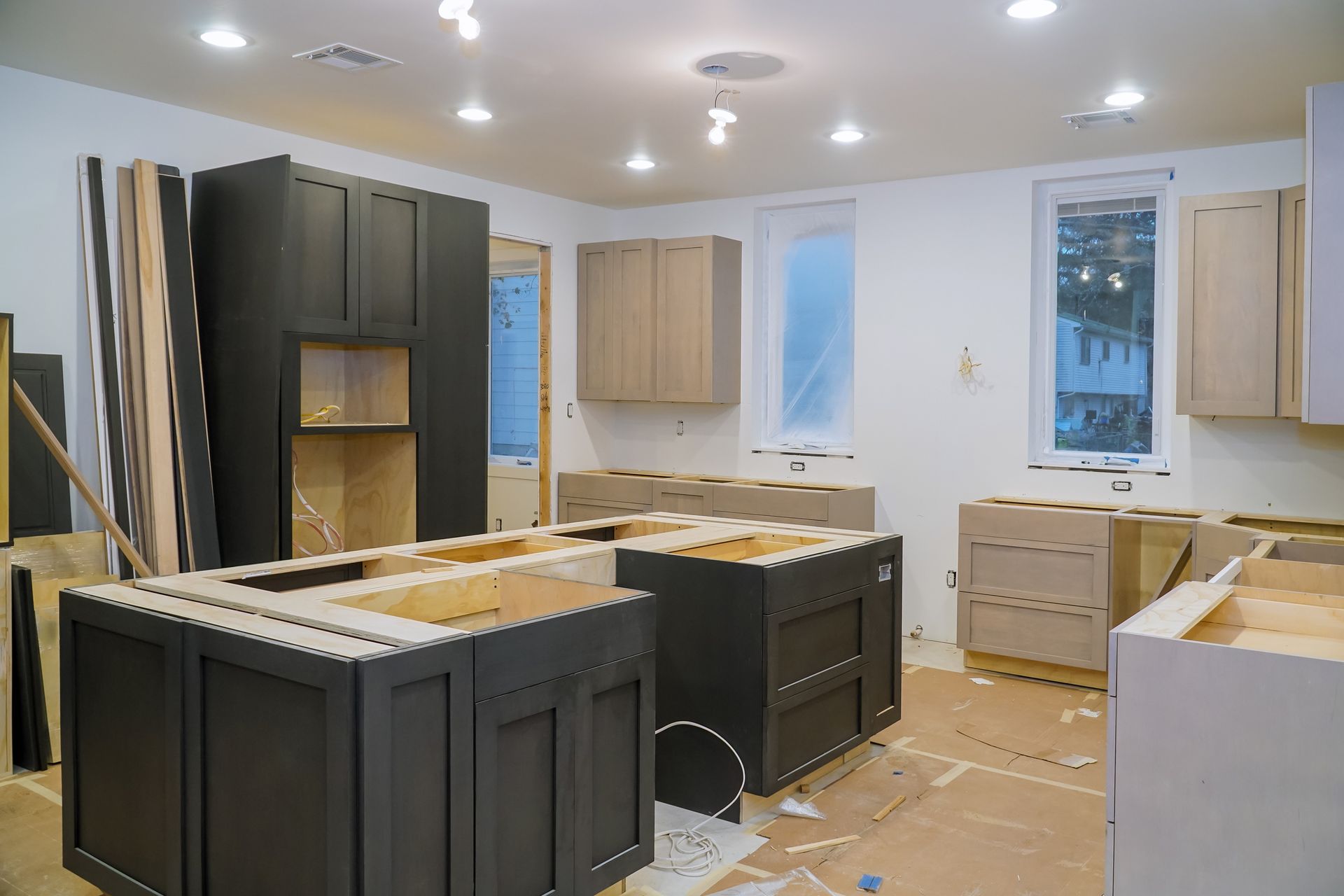 A kitchen under construction with lots of cabinets and drawers.